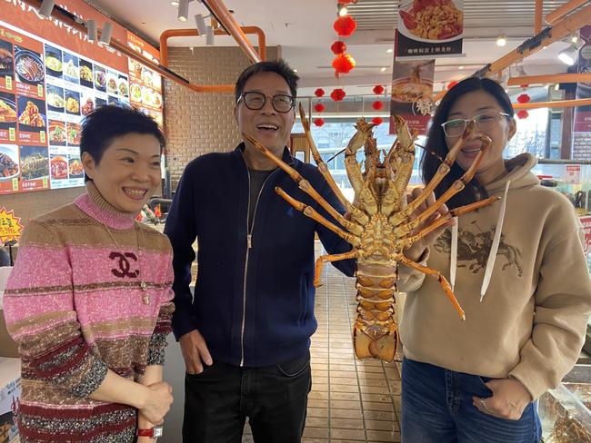 Fan Xubin (C) and friends selecting an Australian lobster for a Chinese New Year lunch in Beijing. Picture: Will Glasgow