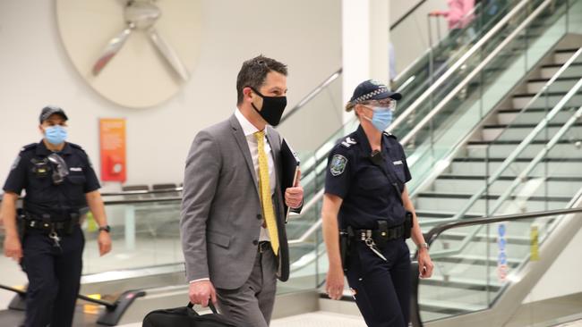 Senator Alex Antic is escorted by police through Adelaide Airport on Thursday night. Picture: Dean Martin