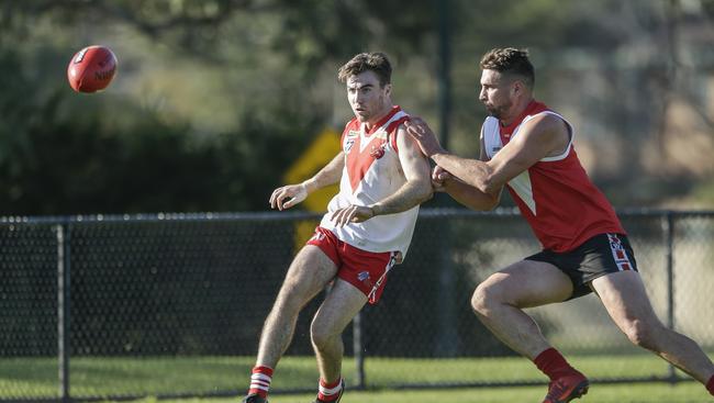 Karingal’s Nathan McDonald boots the Bulls into attack against Red Hill on Saturday. Picture: Valeriu Campan