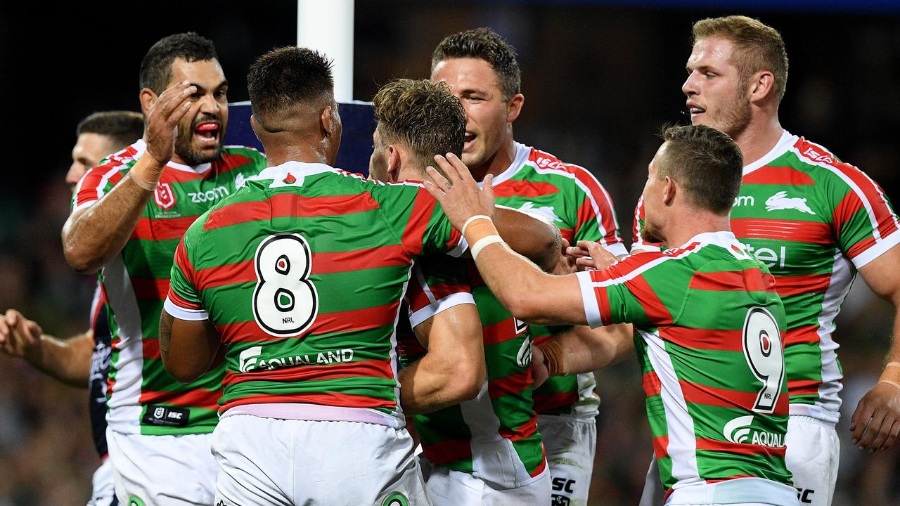 Rabbitohs lock Cameron Murray (centre) celebrates with teammates after scoring a try off the boot of Adam Reynolds.