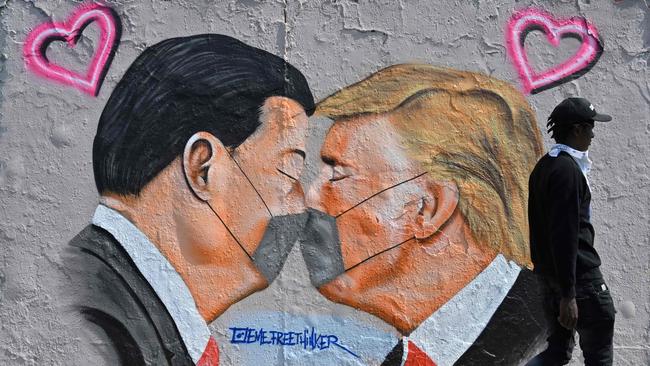 A Berlin mural painting depicting US President Donald Trump and Chinese President Xi Jinping wearing face masks amid the COVID-19 pandemic. Picture: AFP