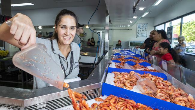 Tori Van Graan dishing up some prawns at Morgans Seafood Market and Takeaway, Scarborough. COVID-19 restrictions. Picture: Renae Droop