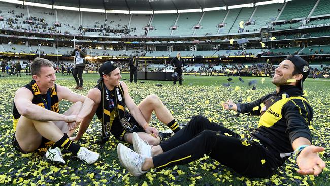 Dylan Grimes and David Astbury celebrate the 2019 AFL grand final win with their mentor Alex Rance. Picture: Getty Images