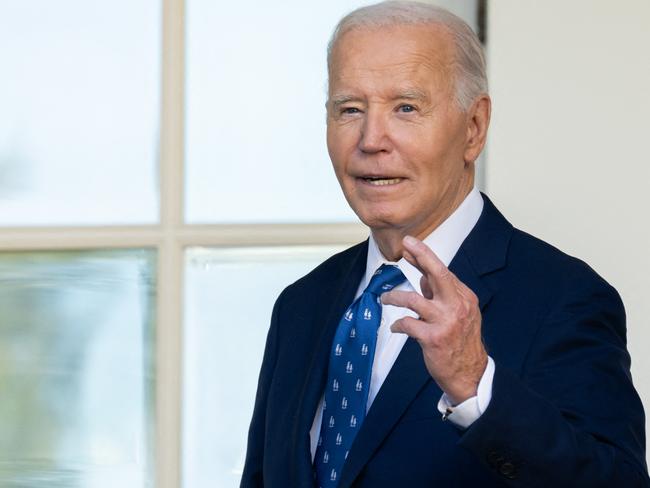 US President Joe Biden crosses his fingers as he answers a question about a Gaza ceasefire after speaking in the Rose Garden of the White House on November 26, 2024, in Washington, DC. Biden on November 26 welcomed as "good news" a US and French-brokered ceasefire between Israel and Hezbollah in Lebanon. The deal will come into force on November 27 at 4:00 am local time (0200 GMT), Biden said, speaking at White House as Israeli Prime Minister Benjamin Netanyahu's office announced his ministers had approved the deal. (Photo by SAUL LOEB / AFP)