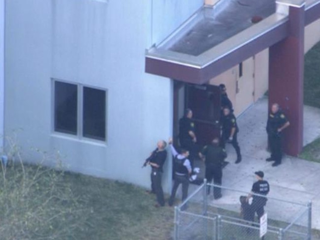 Aerial footage from CNN affiliate WSVN showed a number of people lying on the ground outside the school, being treated for injuries and moved to ambulances. Picture: WSVN