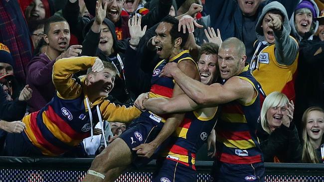 Eddie Betts celebrates his goal against North Melbourne in 2014 with teammates Matthew Wright and Scott Thompson. Photo Sarah Reed.