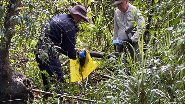 A policeman and grave archaeologist bag the 11th piece of evidence in the search for William Tyrrell. Picture: Liam Mendes