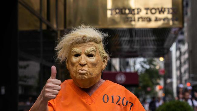 Trumped up: A protester dressed up as the former US President poses for photos outside Trump Tower in New York. Picture AFP