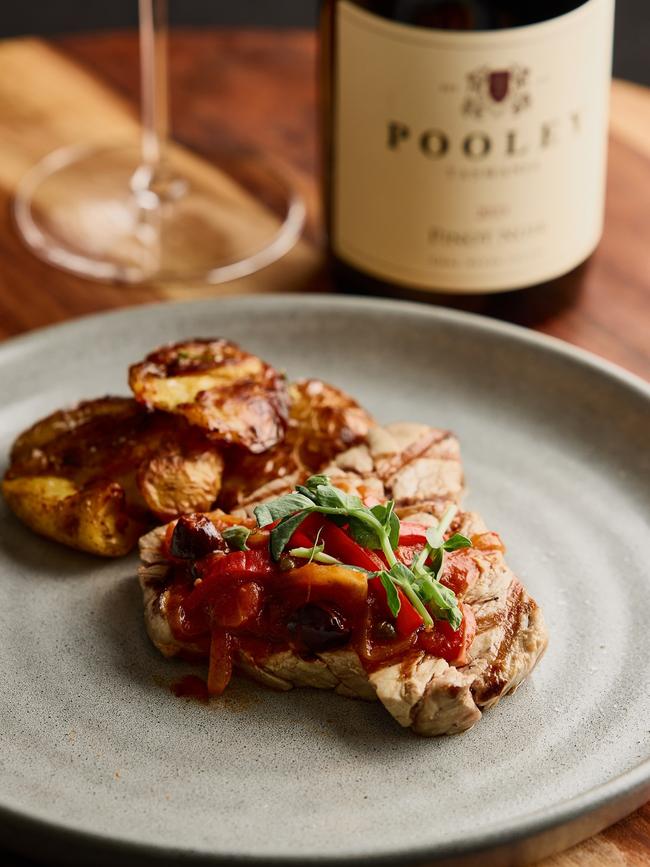 The third course of the Southern Bluefin dinner is a tuna steak that’s grilled medium-rare and topped with capsicum, tomato, capers piperade and served with thrice-cooked potatoes. Picture: Samuel Shelley