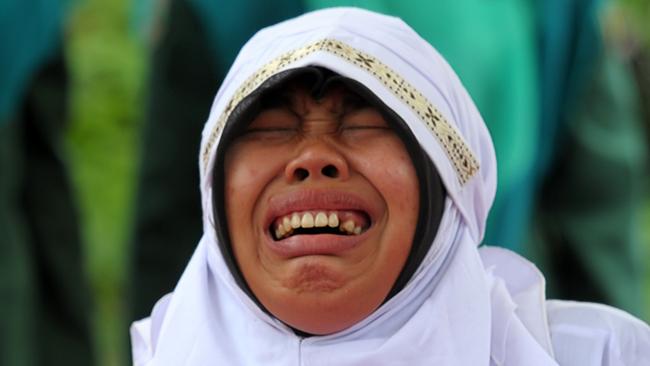 A Muslim woman cries out as she gets caned for being caught in proximity with a male in Banda Aceh on October 17, 2016. Indonesia's Aceh province has gained international infamy for its strict Islamic laws. Picture: AFP