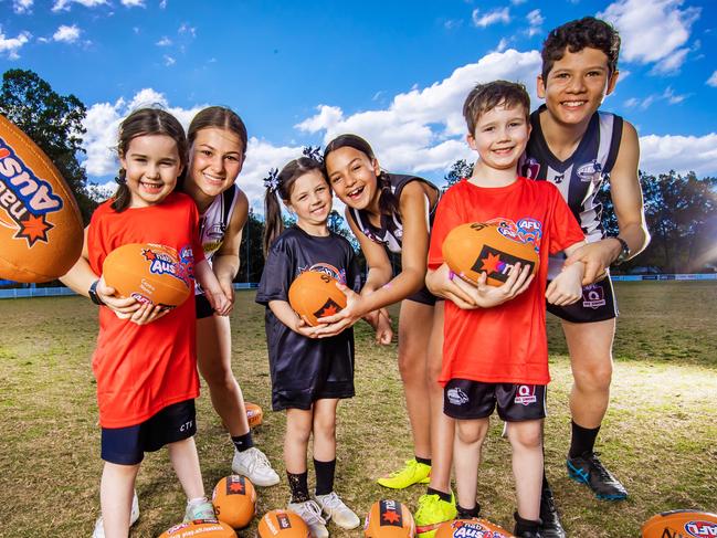 AFL Auskick kids for story about AFL junior participation numbers.Sherwood Magpies juniors Sophie David, 16, Leilani Hockley, 12 and Eli Jessen, 12 with Auskick kids Abigail Keane, 5, Harper Hopkins, 5 and Matthew Keane, 7.Picture: Nigel Hallett*****Chris Keane (DAD) 0414354242*****