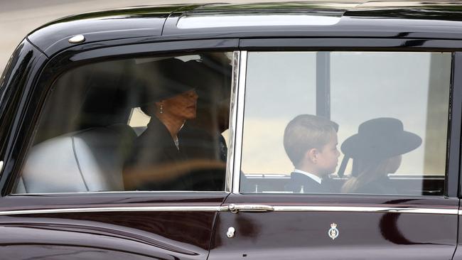 The Princess of Wales with the Queen Consort Camilla, Prince George and Princess Charlotte are seen in a car outside Westminster Abbey. Picture: AFP