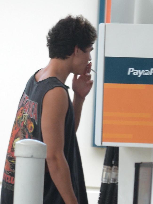 Calum Hood smoking at the bowser / Picture: Jayden Seyfarth