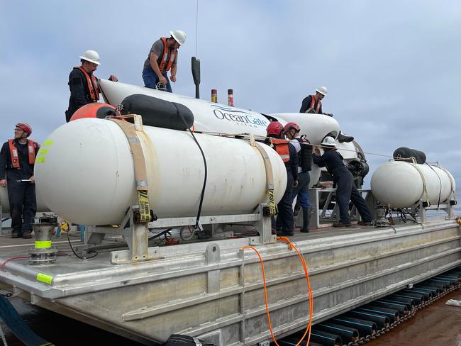 A OceanGate maintenance crew hecks over the Titan submersible. In a post to Facebook, OceanGate Expeditions wrote: 