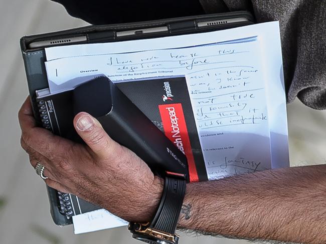 Jose Mourinho is pictured carrying written notes as he returns to his home in London yesterday.