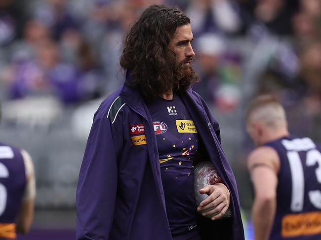 PERTH, AUSTRALIA - JULY 21: Alex Pearce of the Dockers walks from the team huddle with ice on his left forearm at the three quarter time break during the round 19 AFL match between Fremantle Dockers and Melbourne Demons at Optus Stadium, on July 21, 2024, in Perth, Australia. (Photo by Paul Kane/Getty Images)