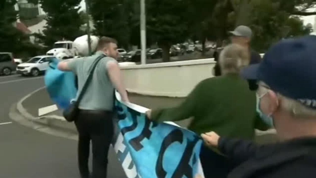 ‘Australian of the year’: Man rips down banner of climate protest blocking traffic