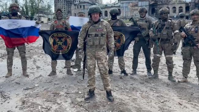 A video grab taken from a handout footage posted on May 20 on the Telegram account of the press service of Concord shows Yevgeny Prigozhin holding a Russian national flag in front of his soldiers in Bakhmut. Picture: via AFP