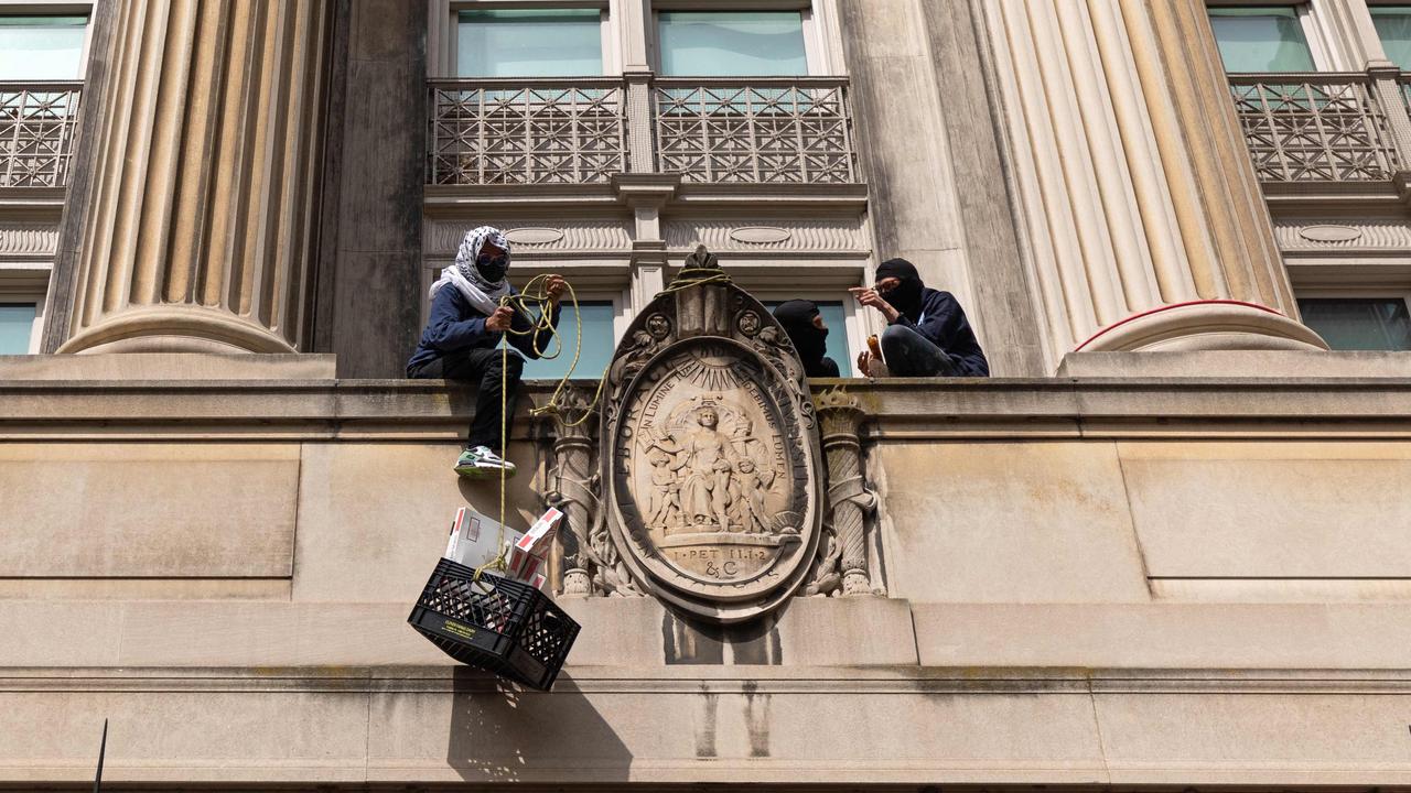 Pro-Palestinian student protesters pull a crate with pizza boxes inside from a balcony in Hamilton Hall at Columbia University. Picture: Emily Byrski / AFP