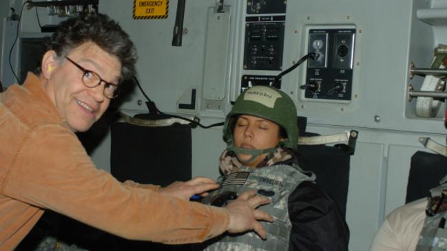 US Senator Al Franken poses for a photo where he appears to grope broadcaster Leeann Tweeden.