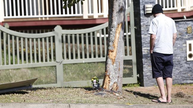 The fatal accident scene along Somerset Drive in Mudgeeraba where an 18-year-old man died on Saturday night. The boy’s father at the scene on Sunday morning. Picture: Gold Coast Bulletin.