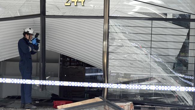 Police at a tobacconist at South Melbourne that was ram raided. Picture: Andrew Henshaw