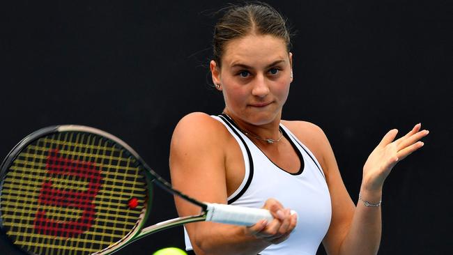 Ukraine's Marta Kostyuk hits a return against Amanda Anisimova of the US during their women's singles match on day one of the Australian Open tennis tournament in Melbourne on January 16, 2023. (Photo by Paul CROCK / AFP)