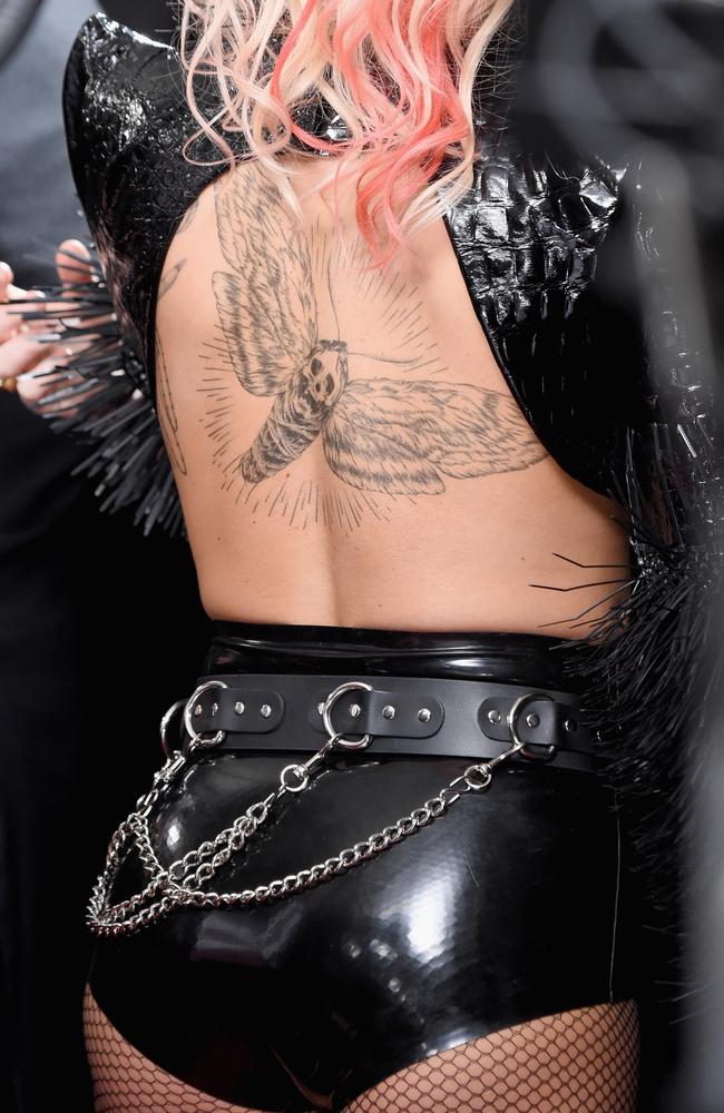 Lady Gaga showed off her Metallica moth-inspired tatt. Picture: AFP