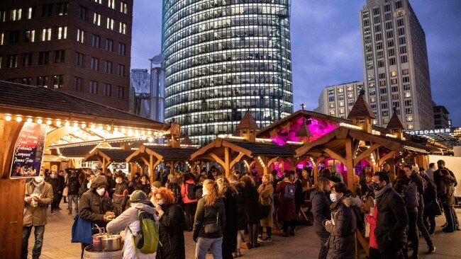 Germans stand at a Christmas market at Potsdamer Platz on November 19, 2021 in Berlin. The Bundestag, Germany's parliament, on Thursday approved a bill that would impose restrictions, particularly on the unvaccinated, should hospitalisations reach specific levels due to COVID-19. Picture: by Maja Hitij/Getty Images