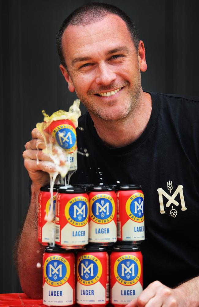 Mismatch Brewing head brewer Ewan Brewerton with cans of Lager.