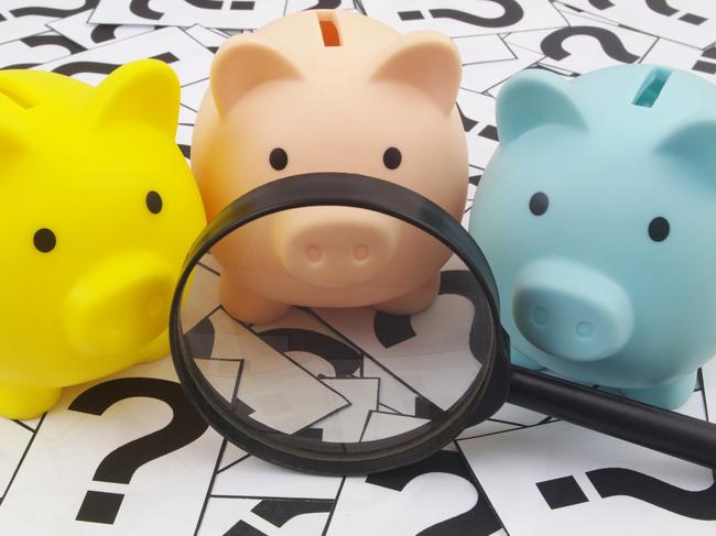 Three piggy banks under magnifying glass on question marks background. Saving money concept; superannuation saving generic