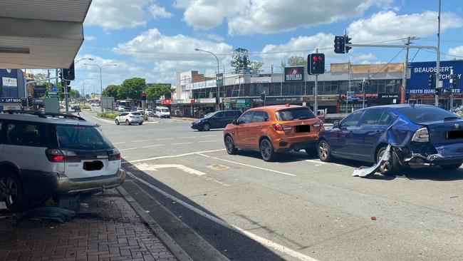 A man in his 70s is in hospital after hitting the accelerator instead of his brakes, crashing into two other cars and a business in the Gold Coast hinterland. Photo: Facebook.