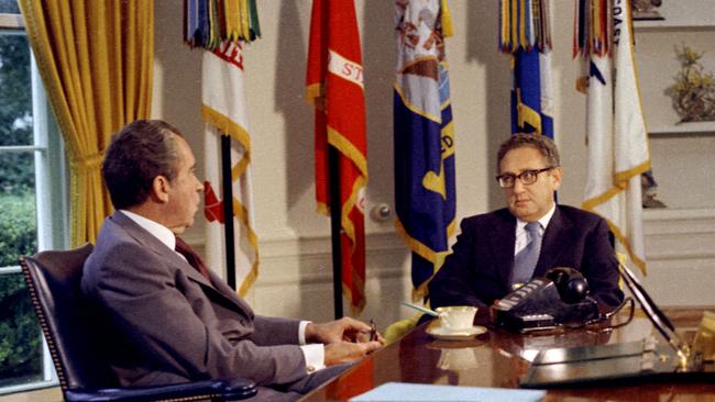 Secretary of State Henry Kissinger (R) sits with President Richard Nixon in the Oval Office in the White House in 1973.