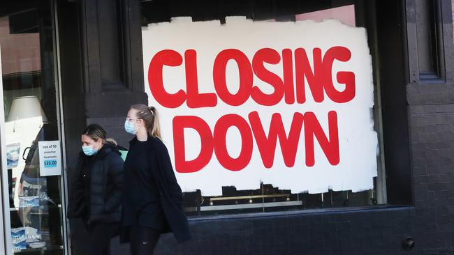 People walk past a closing down sign in Brunswick street during COVID-19 lockdown in Melbourne. Picture: NCA NewsWire/ David Crosling