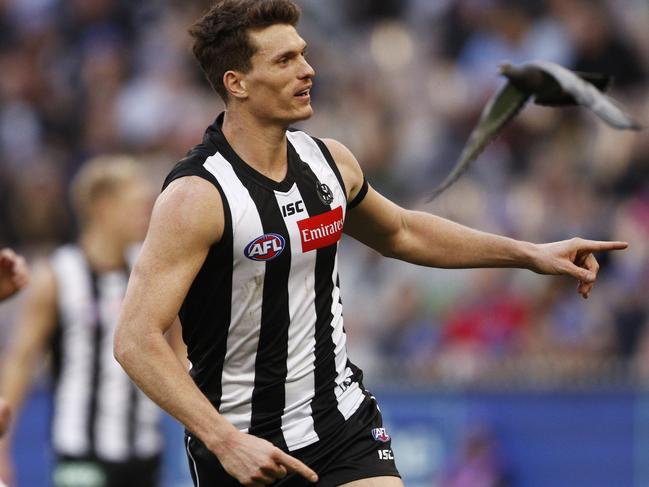 Brody Mihocek of the Magpies celebrates a goal as a pigeon flies past during the Round 12 AFL match between the Collingwood Magpies and the Melbourne Demons at the MCG in Melbourne, Monday, June 10, 2019. (AAP Image/Daniel Pockett) NO ARCHIVING, EDITORIAL USE ONLY