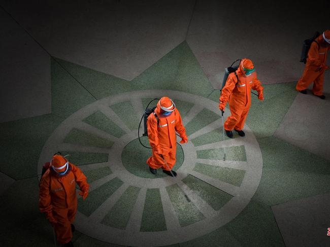 TOPSHOT - This picture taken on May 17, 2022 and released from North Korea's official Korean Central News Agency (KCNA) on May 18 shows railway station staff disinfecting Pyongyang station premises as a prevention measure against the Covid-19 coronavirus. (Photo by KCNA VIA KNS / AFP) / - South Korea OUT / ---EDITORS NOTE--- RESTRICTED TO EDITORIAL USE - MANDATORY CREDIT "AFP PHOTO/KCNA VIA KNS" - NO MARKETING NO ADVERTISING CAMPAIGNS - DISTRIBUTED AS A SERVICE TO CLIENTS THIS PICTURE WAS MADE AVAILABLE BY A THIRD PARTY. AFP CAN NOT INDEPENDENTLY VERIFY THE AUTHENTICITY, LOCATION, DATE AND CONTENT OF THIS IMAGE. /