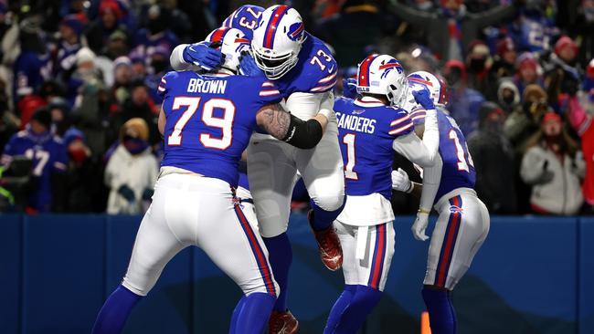 BUFFALO, NEW YORK - JANUARY 15: Spencer Brown #79 and Dion Dawkins #73 of the Buffalo Bills celebrate a touchdown against the New England Patriots during the fourth quarter in the AFC Wild Card playoff game at Highmark Stadium on January 15, 2022 in Buffalo, New York. (Photo by Timothy T Ludwig/Getty Images)