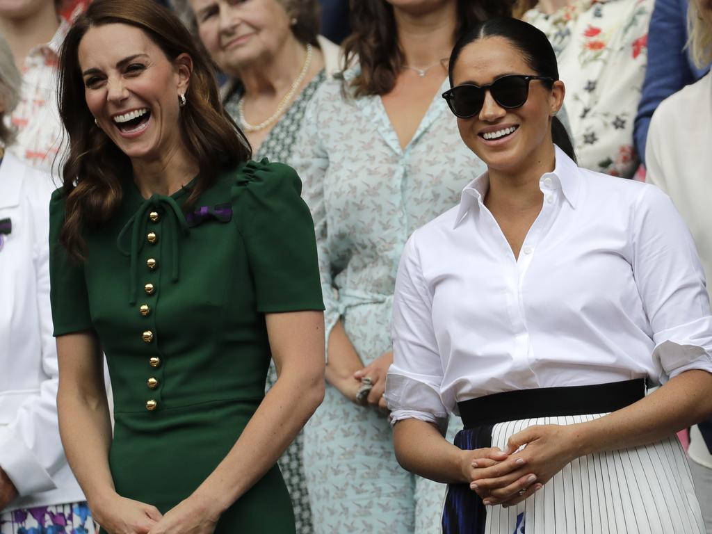 Kate, Duchess of Cambridge and Meghan, Duchess of Sussex, stand together during the women's singles final.