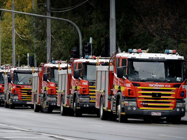 MELBOURNE, AUSTRALIA - NewsWire Photos JULY 7: Fire crews parked along Mount Alexander Road behind the Flemington public housing estate after it was put into lockdown on Saturday. Picture: NCA NewsWire / Andrew Henshaw