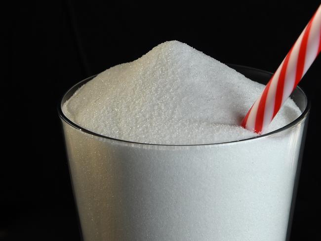 A stock image of white sugar in a glass with a drinking straw, Friday, Aug. 19, 2016. (AAP Image/Dan Peled) NO ARCHIVING