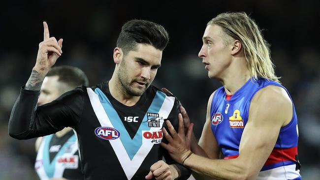 Chad Wingard celebrates his goal ahead of Roarke Smith. Picture Sarah Reed