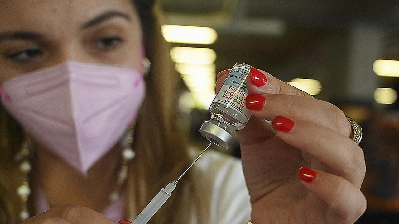 A health worker prepares a dose of the Moderna vaccine.