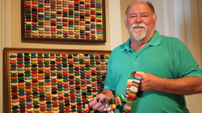 Historian Paul Armstrong with his sheep ear tag collection. Picture: Supplied by ABC Radio Broken Hill