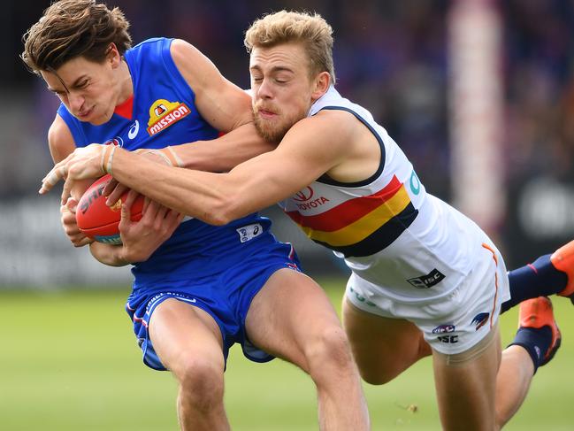 Crow Hugh Greenwood tackles the Bulldogs’ Patrick Lipinski in his last game for the club in August. Picture: Quinn Rooney/Getty Images.