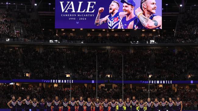 The Fremantle Dockers and Sydney Swans paid their respects to Mr McCarthy during a recent game. Picture: Kane / Getty Images