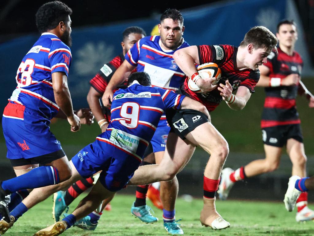 Mariners' Braydn Croft busts through a tackle in the FNQ Rugby grand final match between the JCU Mariners and the Barron Trinity Bulls, held at Barlow Park Picture: Brendan Radke