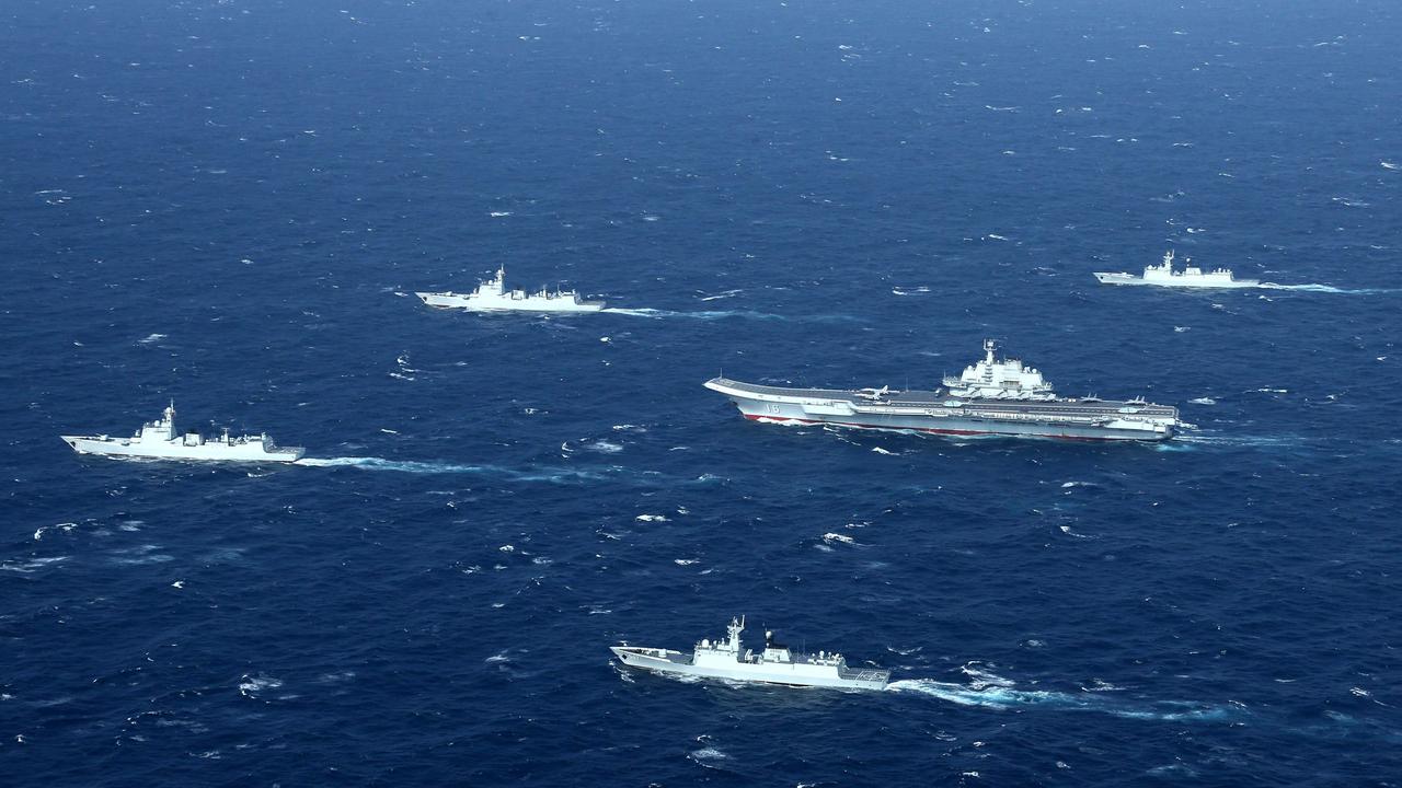 Chinese warships, including the aircraft carrier Liaoning, centre, during 2017 drills in the South China Sea. Picture: STR/AFP