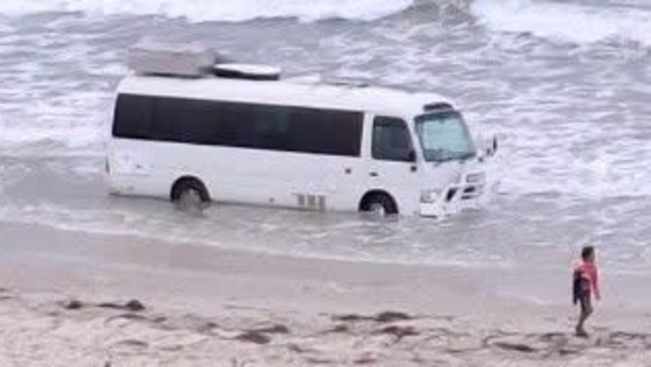 ‘Can’t park there mate’: Bus bogged on Adelaide beach