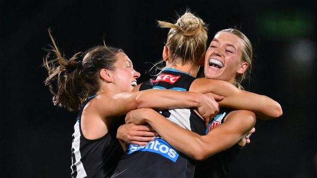 MELBOURNE, AUSTRALIA - NOVEMBER 16: Ashleigh Saint,  Ella Boag and Kirsty Lamb of the Power celebrate winning the AFLW Semi Final match between Hawthorn Hawks and Port Adelaide at Ikon Park, on November 16, 2024, in Melbourne, Australia. (Photo by Quinn Rooney/Getty Images)