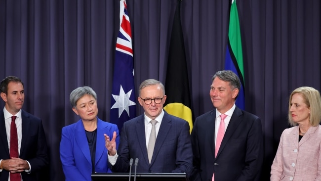 The Australian flag alongside the Aboriginal and Torres Strait ensigns at Anthony Albanese's first press conference as Prime Minister. Picture: David Gray/Getty Images